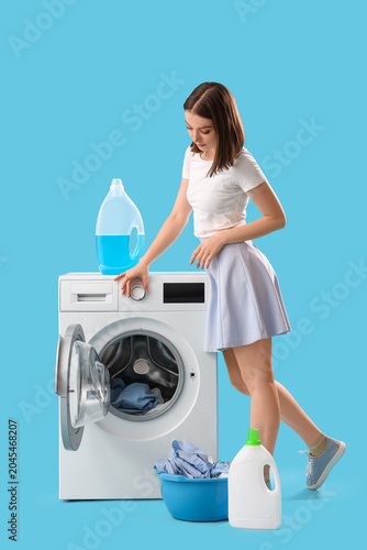 Young woman with washing ma...