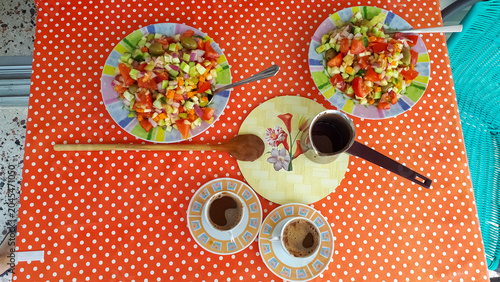 Bild auf Leinwand Colorful fruit salad and coffee on a polka dot tablecloth.