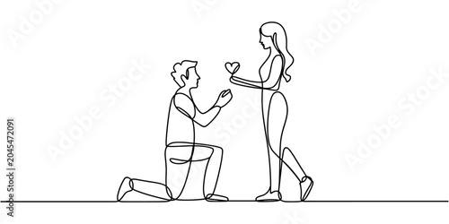 Photos Man kneeling down proposing to woman with heart shaped ring proposal engagement