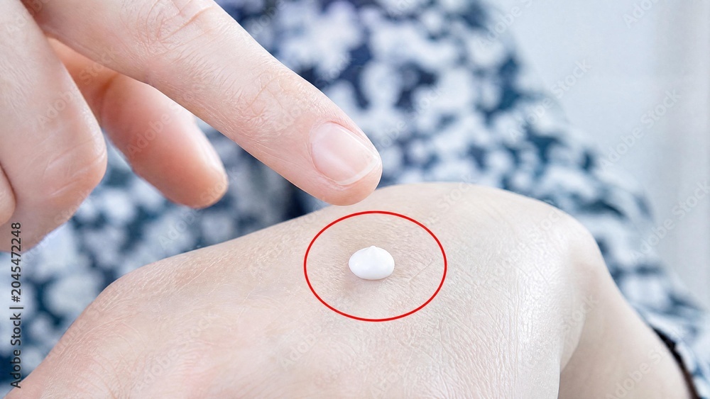 Fototapeta premium Woman Applying Moisturizing Cream on Hand Close Up