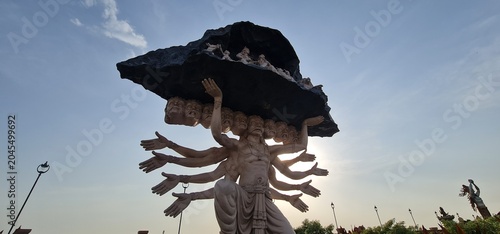 Giant Multi Armed Mythological Statue Lifting Mountain at Ujjain Corridor Against Bright Sun