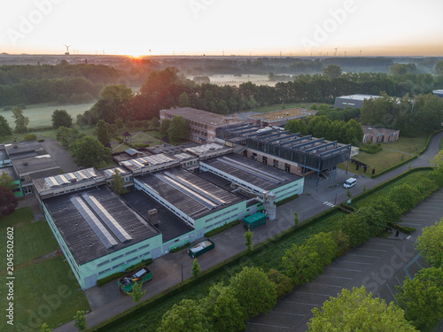 Diepenbeek, Belgium. Aerial drone view of Provinciale School Diepenbeek campus with solar panels and sustainable infrastructure at sunrise