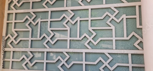 Close Up View of Intricate White Carved Jali Work Screen with Symmetric Lines