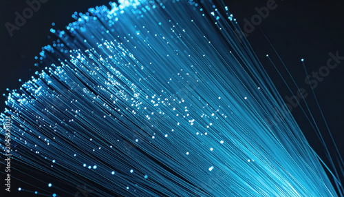 Close-up of bright blue fiber optic strands glowing with light particles on dark background