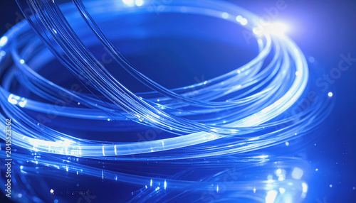 Close-up of glowing blue fiber optic strands forming a circular pattern on a dark surface
