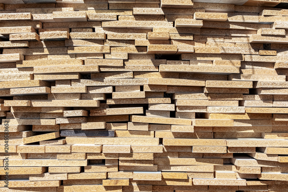 Fototapeta premium A stack of particle board panels at a lumberyard.