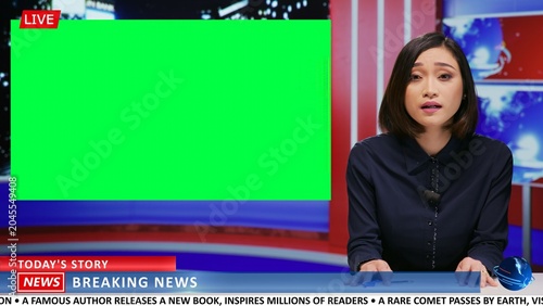 Fotografie Asian journalist does newscast with greenscreen on live tv program, presenting daily news and important events