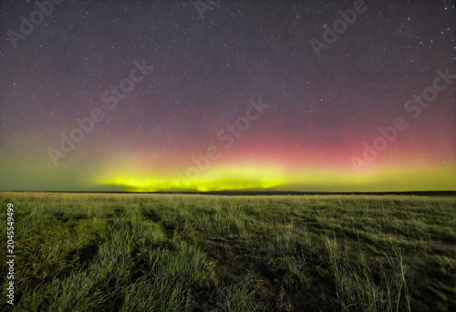Green aurora Borealis over landscape