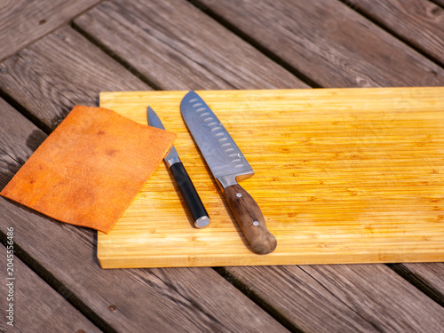 chopping board and two kitchen knives