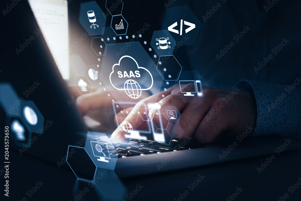 Naklejka premium Saas tools and cloud computing concepts displayed on a laptop screen with hands working
