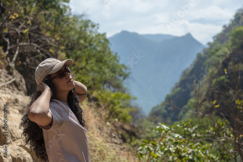 Cuadro en lienzo Photo of a female tourist enjoying the experience of nature tourism, hiking in t