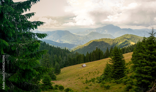Fényképezés Panoramic mountain landscape rolling forested ridges alpine meadow rustic cabin