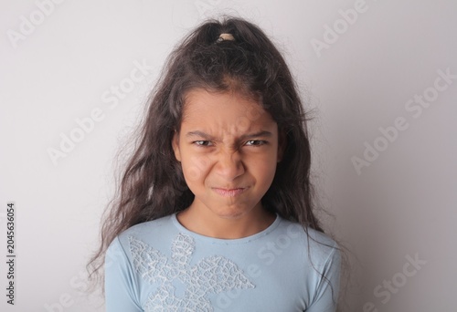 Annoyed young girl making an angry face