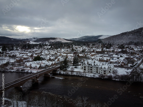 Photography Old stone bridge over Dee river aerial view in Ballater by winter, Scotland