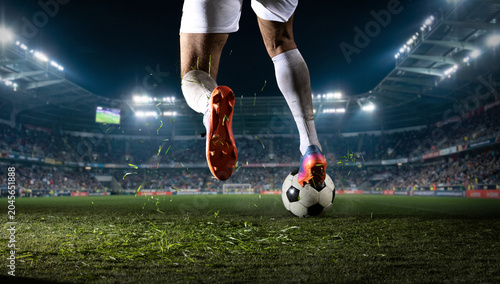 Photos Soccer player stepping on ball during night match in stadium