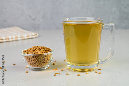 Fenugreek water in a glass cup.