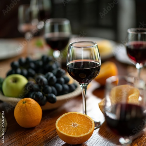 Colorful Fruits and Wine Glasses on a Table During a Social Gathering