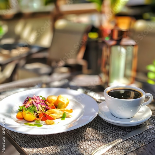 Morning Meal With Coffee and Salad by the Window in a Brightly Lit Space