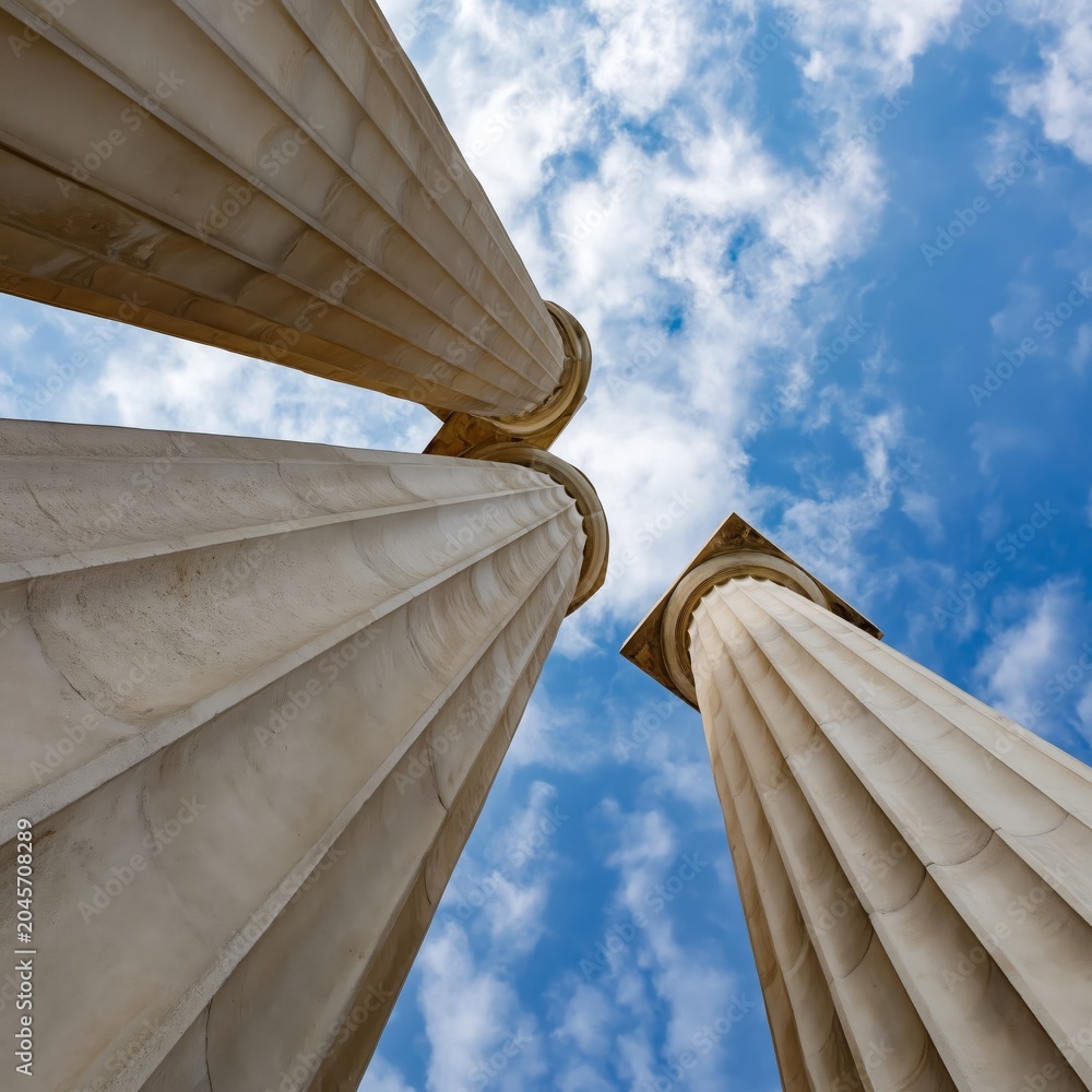 Naklejka premium Light Shines Through Columns at a Historic Building Under a Clear Sky With Clouds
