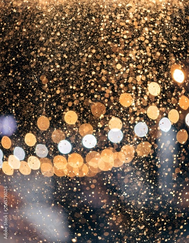 Golden Glitter Bokeh Lights Background with Sparkling Festive Glow.