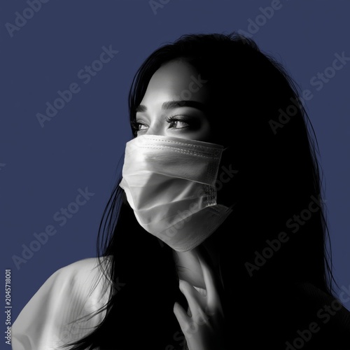 Woman Wearing a Blue Mask Looking Away From Colorful Background During Daytime