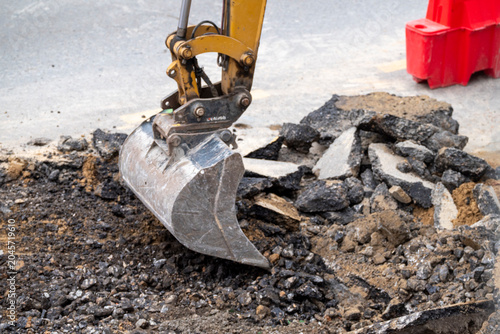 Industrial machinery digging at a road site The Concept of infrastructure and development