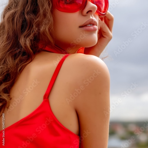 Woman With Red Sunglasses Poses in Front of Pink Background With Palm Leaves ...