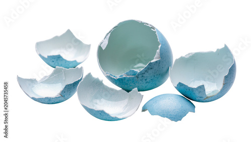 Foto Cracked blue and white speckled eggshells broken into pieces, isolated on transp
