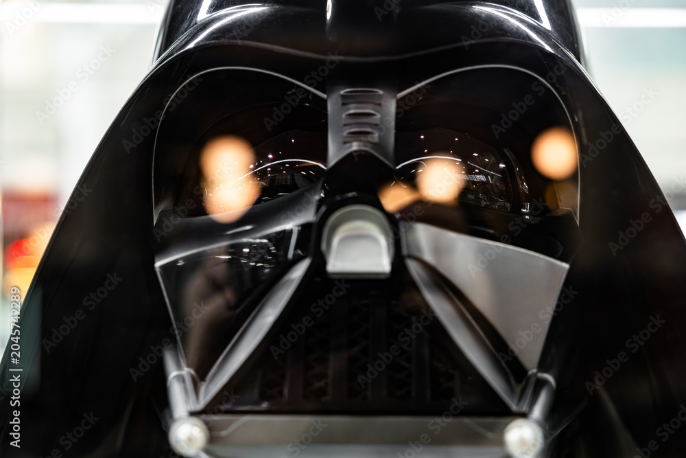 Naklejka premium Darth Vader black helmet macro view with light reflections in mask lenses