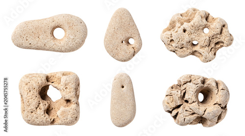 Obraz na plátně Selection of authentic hag stones with naturally occurring holes and rough textures, isolated for design