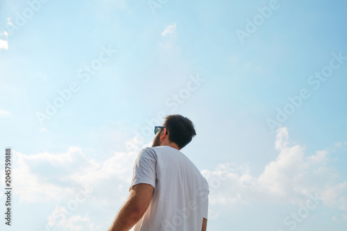 Photography Man looking up at the blue sky on a sunny day