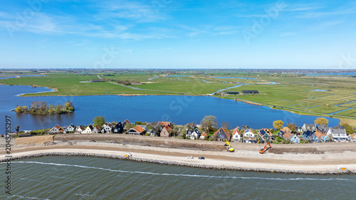 Принти на полотні Dike reinforcement work with village houses along an inland lake in Europe