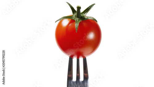 Foto Ripe red cherry tomato impaled on a metal fork, isolated on transparent backgrou