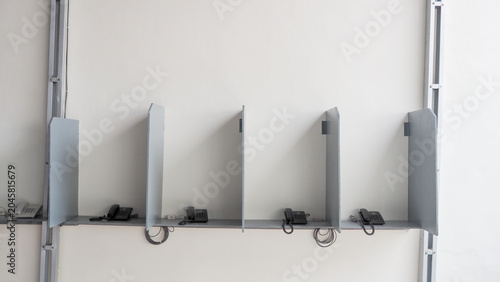 Quadro su tela Gray metal partitions stand aligned in a clean, minimalist space