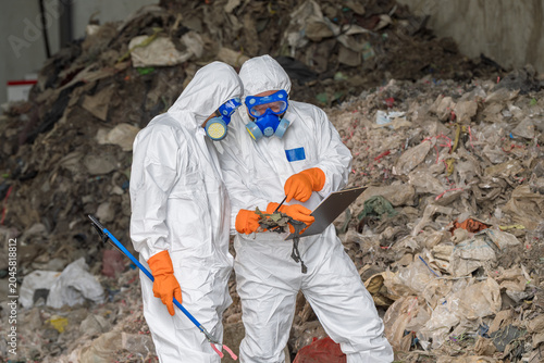 Asbestos Protection:Workers in Protective Suits:Workers in protective suits,gas masks,operating near potentially asbestos-containing materials.Emphasizing for safety, health,environmental protection.
