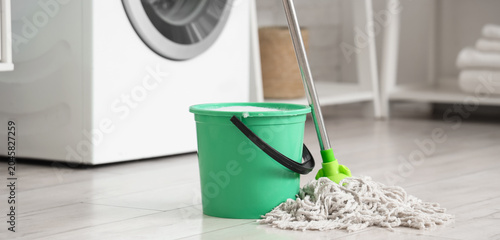 Mop with green bucket of wa...