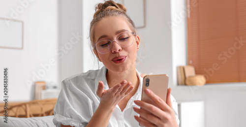 Pretty young woman using mo...