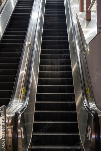 Close up view of escalator steps with metallic handrails