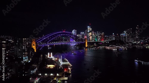 Up over Lavender bay on Sydney harbour at Vivid Sydney night light show aerial view.