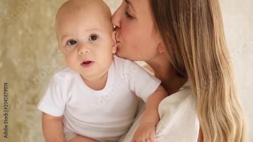 mother and baby hugging and kissing at home, mother's love and care, mother and child, mother playing with a small child