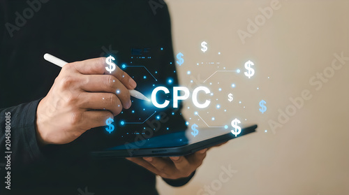 Hand holding tablet with cpc cost per click concept showing money and digital marketing network