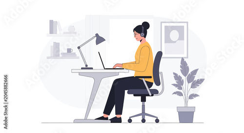 Woman working on laptop at desk with headphones, modern home office setup