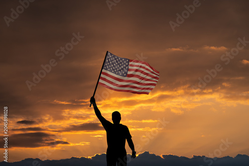 Man with National flag of United States of America in sky