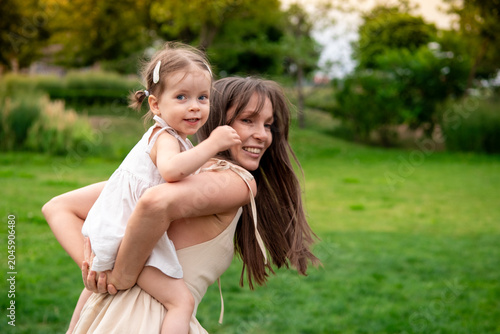 Принти на полотні a mother and a child playing and having fun in a park, a mother and a baby walki