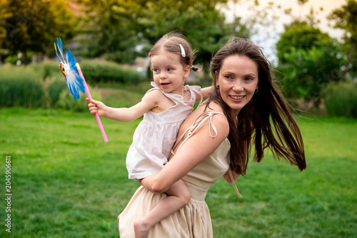 Photos a mother and a child playing and having fun in a park, a mother and a baby walki