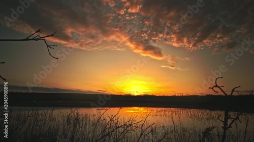 Magical sunset timelapse over calm lake Vinnytsia region Ukraine. Beautiful dramatic evening sky changing colors, fast moving clouds reflecting water surface. Peaceful countryside nature scenery, summ