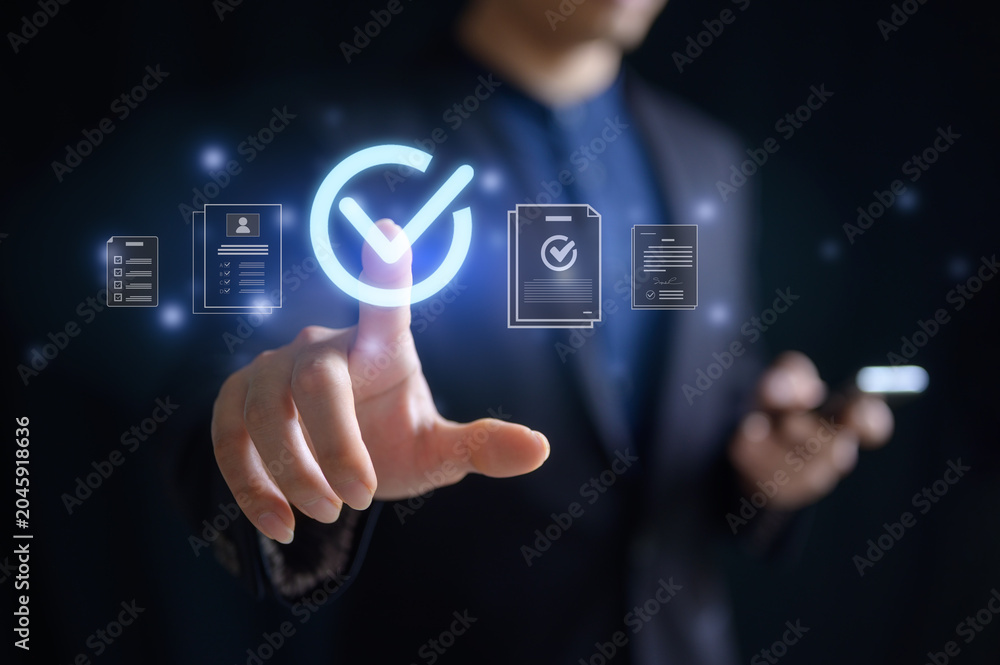 Fototapeta premium Businessman pointing at virtual tick mark on screen in concept of practices and policies , procedure company articles of association Terms and Conditions compliance rules and law regulation policy.