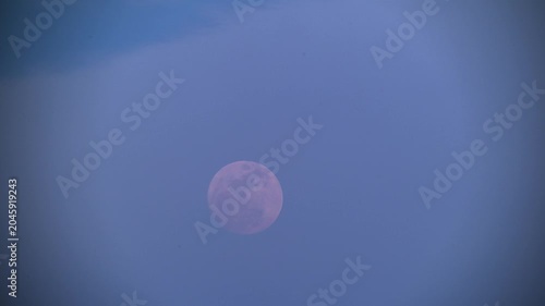A beautiful full moon rising in the clear evening sky over Shimen, New Taipei City, Taiwan, captured during the night.