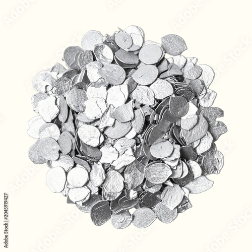Small Pile of Edible Silver Leaf Flakes for Pastry Decoration Isolated on White Background