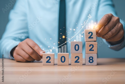 Businessman Building 2028 Growth Strategy and Future Business Success Planning Concept